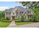 Charming two-story home featuring a well-manicured lawn, beautiful landscaping, and a welcoming front entrance at 7615 Laurel Oak Dr, Suwanee, GA 30024