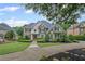 Charming two-story home featuring a well-manicured lawn, mature trees, and a welcoming front entrance at 7615 Laurel Oak Dr, Suwanee, GA 30024