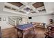 Spacious game room with pool table, coffered ceiling, and hardwood flooring at 7615 Laurel Oak Dr, Suwanee, GA 30024