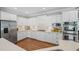 Bright kitchen with white cabinets, stainless steel appliances, and a tiled backsplash at 7615 Laurel Oak Dr, Suwanee, GA 30024