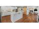 Open concept kitchen with a large island, stainless appliances, and modern finishes at 7615 Laurel Oak Dr, Suwanee, GA 30024