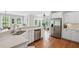Modern kitchen with stainless steel appliances, white cabinets, and a large island for cooking and entertaining at 7615 Laurel Oak Dr, Suwanee, GA 30024