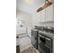 Laundry room with modern washer and dryer and storage cabinets at 7615 Laurel Oak Dr, Suwanee, GA 30024