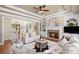 Comfortable living room features a fireplace, staircase, and plenty of seating at 7615 Laurel Oak Dr, Suwanee, GA 30024