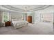 Large main bedroom with sitting area, tray ceilings, and lots of natural light at 7615 Laurel Oak Dr, Suwanee, GA 30024
