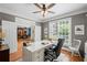 Bright office with a white desk, natural light, and hardwood floors provides a professional and inviting workspace at 7615 Laurel Oak Dr, Suwanee, GA 30024