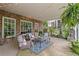 Inviting covered patio featuring brick, string lights, comfortable seating, and an outdoor water fountain at 7615 Laurel Oak Dr, Suwanee, GA 30024