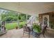 Relaxing covered patio with brick accent, string lights, and stairs leading to the backyard at 7615 Laurel Oak Dr, Suwanee, GA 30024