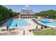 Community clubhouse and pool featuring ample seating and shaded areas for relaxation and recreation at 7615 Laurel Oak Dr, Suwanee, GA 30024