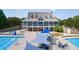 Community pool and clubhouse area featuring lounge chairs, umbrellas, and landscaped surroundings at 7615 Laurel Oak Dr, Suwanee, GA 30024