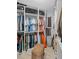 Well-organized walk-in closet with custom shelving, rods, and ample storage space at 7615 Laurel Oak Dr, Suwanee, GA 30024