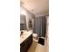 Bathroom features a single sink vanity and a shower with a black and white patterned curtain at 1245 Cedar Oak Ln, Lawrenceville, GA 30043