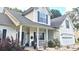 Inviting two-story home featuring a covered front porch with classic columns and an attached two-car garage at 1245 Cedar Oak Ln, Lawrenceville, GA 30043