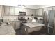 Well-appointed kitchen with granite countertops, stainless steel appliances, and an island with seating at 1245 Cedar Oak Ln, Lawrenceville, GA 30043
