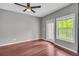 Cozy bedroom with hardwood floors, a ceiling fan, and a door to a balcony at 1250 Parkwood Se Cir # 1213, Atlanta, GA 30339