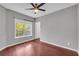 Bedroom features hardwood floors, a ceiling fan, and a view to the outside at 1250 Parkwood Se Cir # 1213, Atlanta, GA 30339