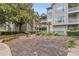 A charming pergola sits in a shared green space with a grill and manicured plants in the Parkwood Place Condominiums at 1250 Parkwood Se Cir # 1213, Atlanta, GA 30339
