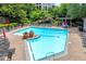 Beautiful community pool surrounded by lounge chairs, picnic area and manicured landscaping at 1250 Parkwood Se Cir # 1213, Atlanta, GA 30339