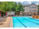 Large community pool with lounge chairs, picnic area and beautifully landscaped surroundings at 1250 Parkwood Se Cir # 1213, Atlanta, GA 30339