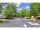 Community entrance gate to the property with brick pillars, mature trees, and well-maintained landscaping at 1250 Parkwood Se Cir # 1213, Atlanta, GA 30339