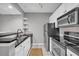 Updated kitchen featuring stainless steel appliances, granite counters, and ample white cabinetry at 1250 Parkwood Se Cir # 1213, Atlanta, GA 30339