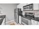 Updated kitchen featuring stainless steel appliances, granite counters, and ample white cabinetry at 1250 Parkwood Se Cir # 1213, Atlanta, GA 30339