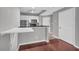Open-concept kitchen with stainless appliances, breakfast bar, and a handy fold-down countertop at 1250 Parkwood Se Cir # 1213, Atlanta, GA 30339