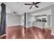 Open-concept living room with hardwood floors, ceiling fan, and a kitchen bar at 1250 Parkwood Se Cir # 1213, Atlanta, GA 30339