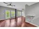 Living area with hardwood floors, dual ceiling fans, and large glass patio doors to a balcony at 1250 Parkwood Se Cir # 1213, Atlanta, GA 30339