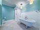 Bathroom with a clawfoot bathtub and a standing shower, with updated tile and lighting at 3836 Loch Highland Ne Pkwy, Roswell, GA 30075