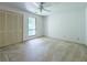 Cozy bedroom featuring a ceiling fan, a window, and a closet with louvered doors at 3836 Loch Highland Ne Pkwy, Roswell, GA 30075