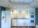 Bright kitchen featuring white cabinets, modern appliances, and a sleek countertop at 3836 Loch Highland Ne Pkwy, Roswell, GA 30075