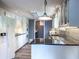 The kitchen features white cabinets, stainless appliances, and modern countertops at 3836 Loch Highland Ne Pkwy, Roswell, GA 30075