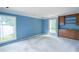 Bright living room featuring lakeside views, natural light, and built-in wooden cabinetry at 3836 Loch Highland Ne Pkwy, Roswell, GA 30075