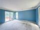 Bright, spacious living room with sliding glass doors and lake view access to outdoor deck at 3836 Loch Highland Ne Pkwy, Roswell, GA 30075