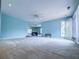 Living room with a ceiling fan, fireplace, mirrored wall, and natural light at 3836 Loch Highland Ne Pkwy, Roswell, GA 30075