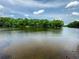 Expansive waterfront view, showcasing the tranquil waters and surrounding lush landscape at 3836 Loch Highland Ne Pkwy, Roswell, GA 30075