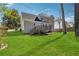 A spacious backyard featuring a deck that connects to the home's upper level, and plentiful green space at 4271 Weston Sw Dr, Lilburn, GA 30047