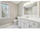 Bright bathroom with a large mirror, white cabinets, and a window with natural light at 4271 Weston Sw Dr, Lilburn, GA 30047