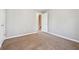 Neutral bedroom features carpet, light grey walls, and a partially opened door at 4271 Weston Sw Dr, Lilburn, GA 30047