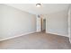 Cozy bedroom with neutral colors, carpeting, and doorway leading to another room for versatile use and comfort at 4271 Weston Sw Dr, Lilburn, GA 30047