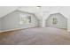 Large carpeted bonus room features vaulted ceilings and two windows offering natural light at 4271 Weston Sw Dr, Lilburn, GA 30047