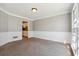 Well-lit dining room features chair rail molding and neutral carpet at 4271 Weston Sw Dr, Lilburn, GA 30047