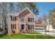 Charming brick two-story home with black shutters, black door, and well-manicured lawn at 4271 Weston Sw Dr, Lilburn, GA 30047