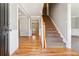 Home foyer with a hardwood floor and carpeted staircase at 4271 Weston Sw Dr, Lilburn, GA 30047