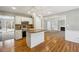 View of kitchen with stainless steel appliances that opens to living room with fireplace at 4271 Weston Sw Dr, Lilburn, GA 30047