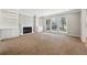 Spacious living room with fireplace, built-in bookshelves, and large windows at 4271 Weston Sw Dr, Lilburn, GA 30047