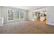Bright living room featuring a wall of windows and carpet floors at 4271 Weston Sw Dr, Lilburn, GA 30047