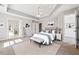 Digitally staged main bedroom showcases a king bed, furniture, decor, and an adjacent sunroom and walk-in closet at 4271 Weston Sw Dr, Lilburn, GA 30047