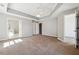 Spacious main bedroom features tray ceilings, neutral paint, and multiple doorways leading to walk-in closet and ensuite bath at 4271 Weston Sw Dr, Lilburn, GA 30047